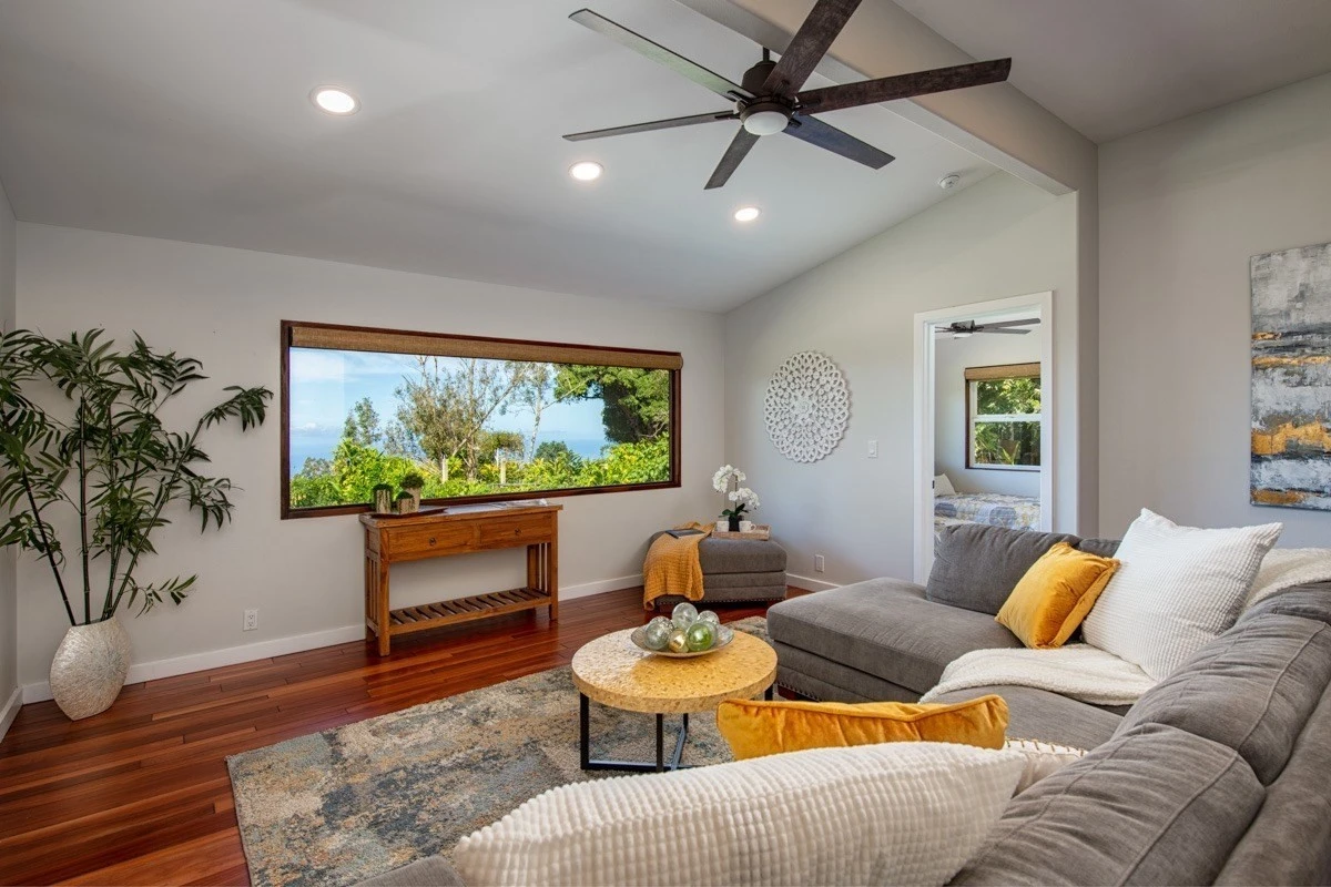 Living room with wide scenic window and gray couch