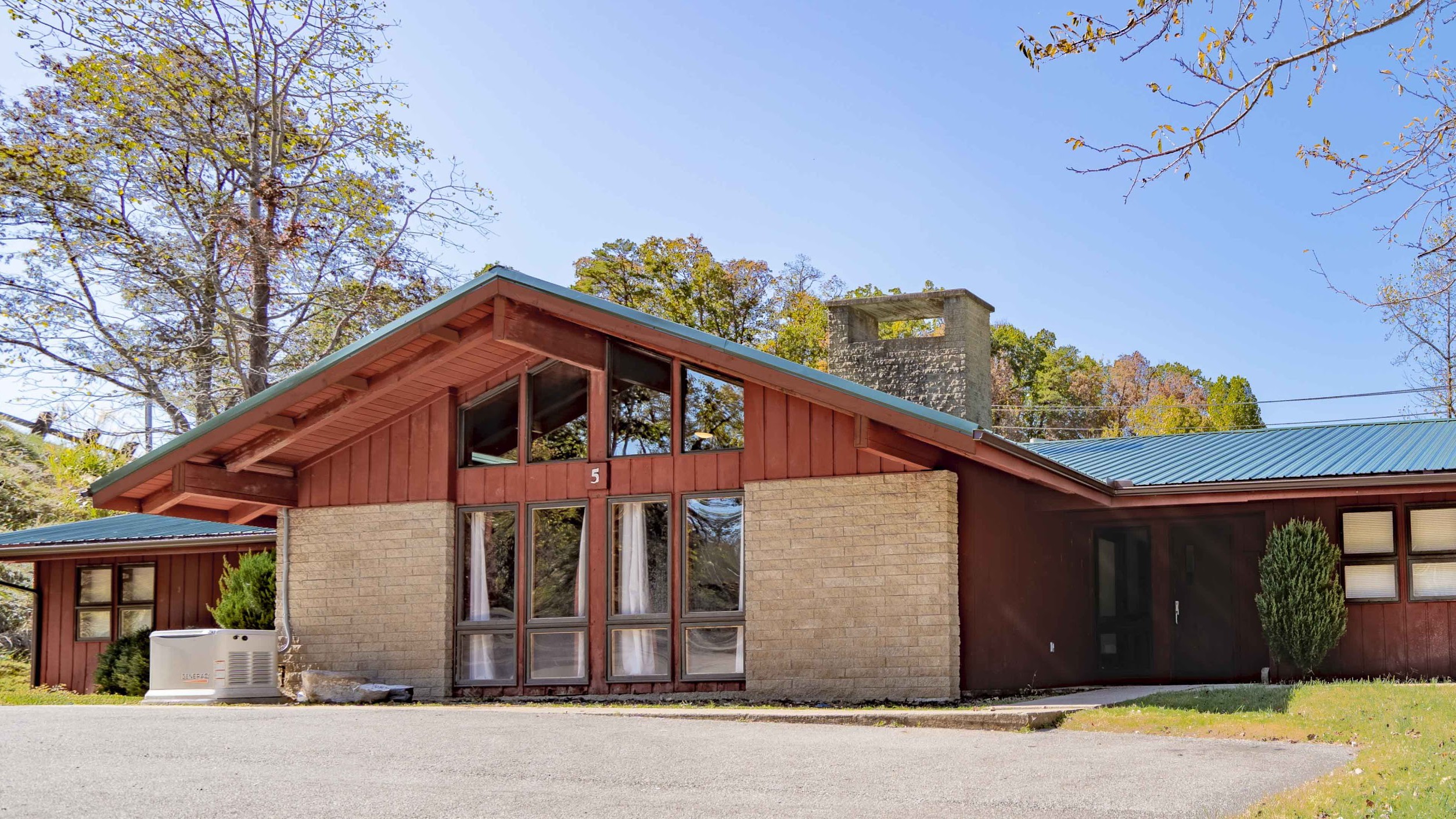 A single-story rehab facility with a green roof and large windows