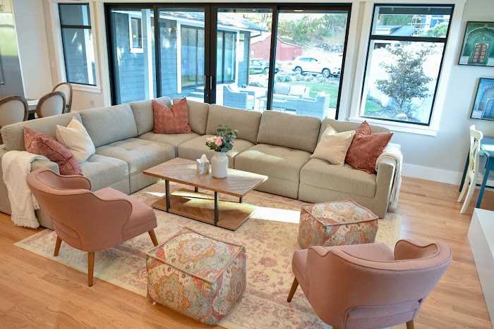 Sectional sofa and pink chairs in cozy living space