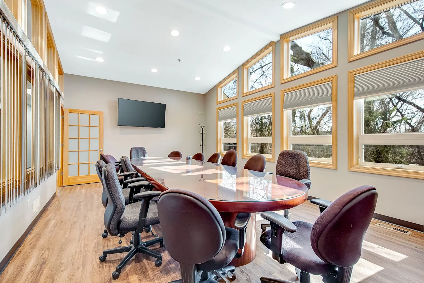 Conference-style room with large table and multiple chairs