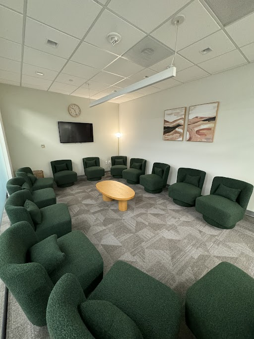 Circular seating area in a spacious therapy room.