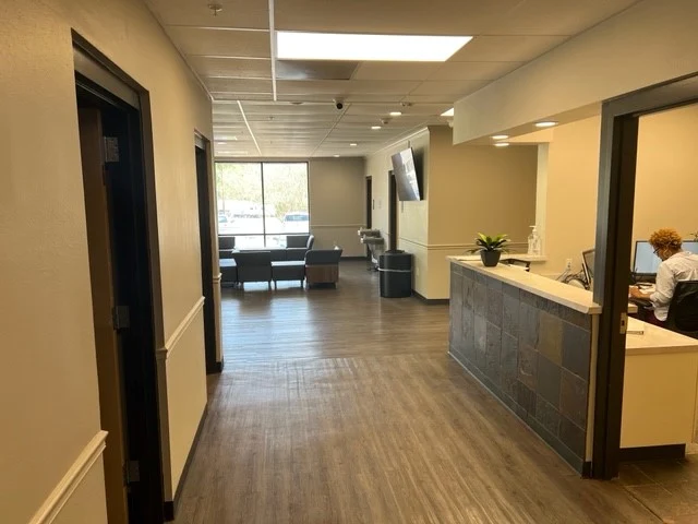 Interior hallway and reception desk at Red River Treatment Center with seating area visible in the background
