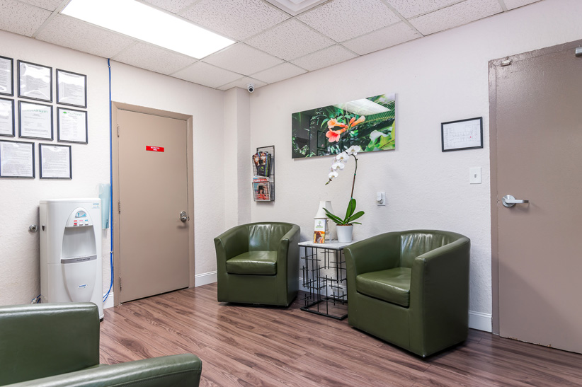Waiting area with chairs, a table, and a water dispenser.