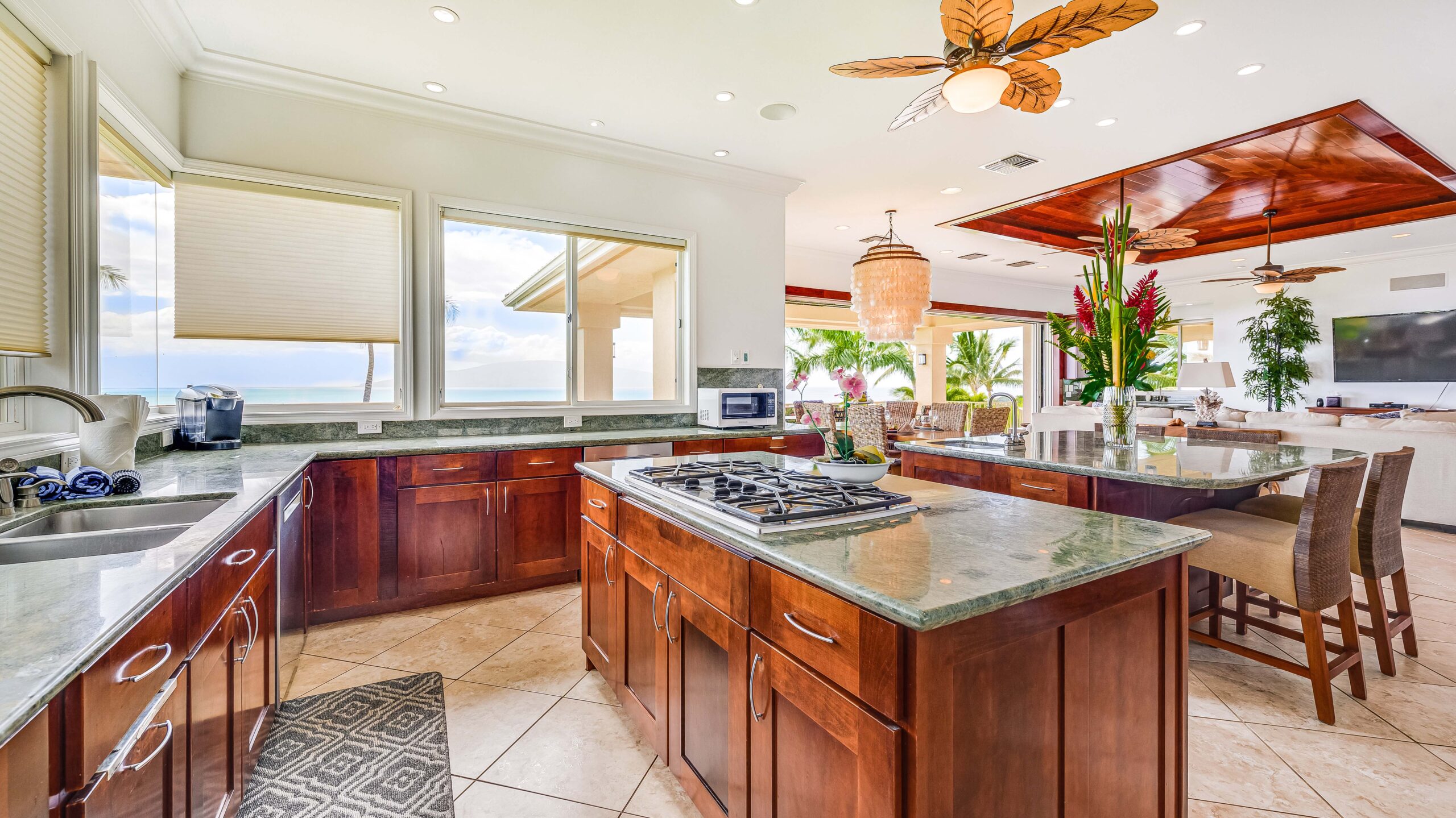 Spacious gourmet kitchen with large island, granite countertops, and ocean views
