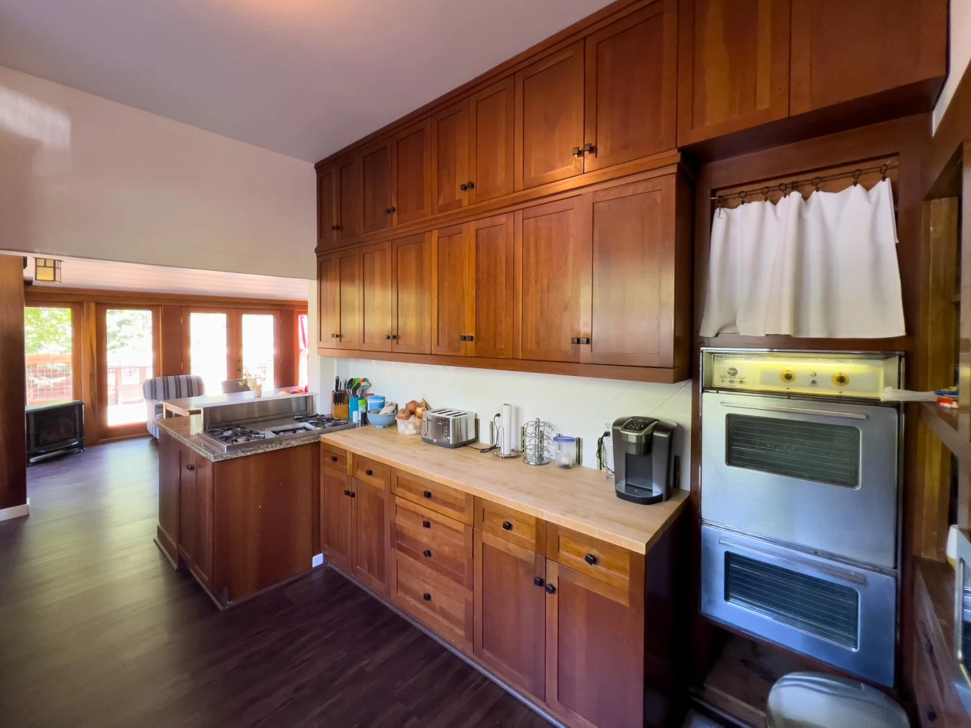 Kitchen with wooden cabinets, oven, and countertop