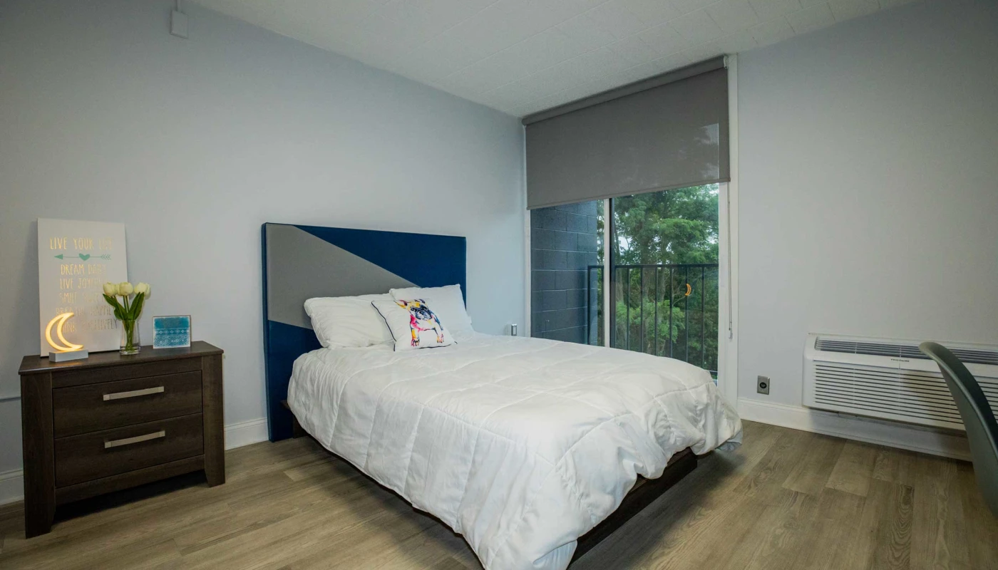 Bright room with bed and balcony window