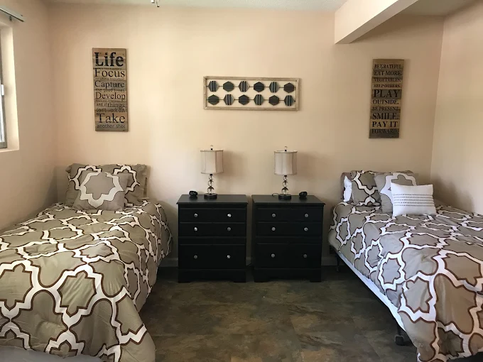 Shared room with two twin beds and nightstands.
