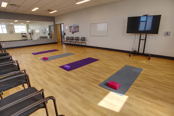 Yoga studio with mats, blocks, and wall mirror