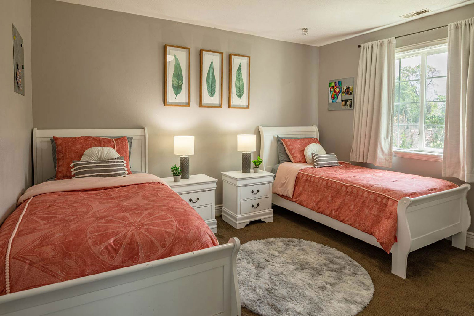 Bright bedroom with coral bedding and twin beds