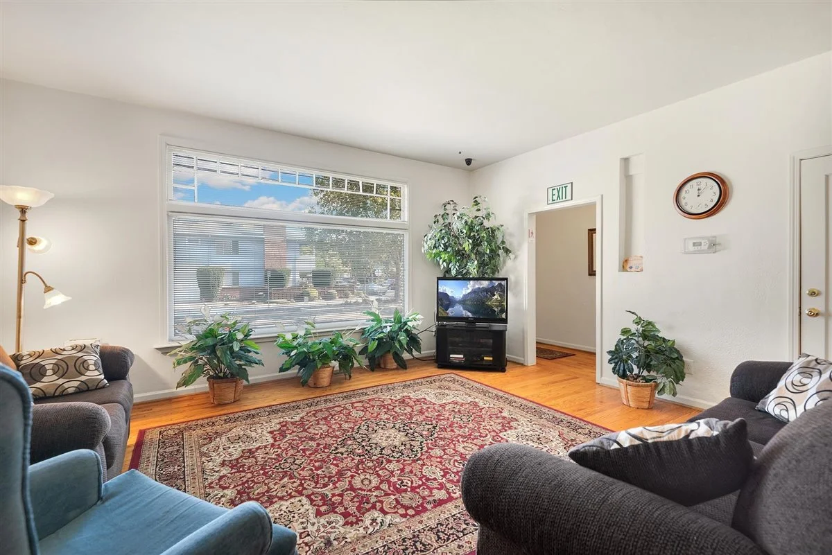 Rehab lounge with couches, rug, and television.