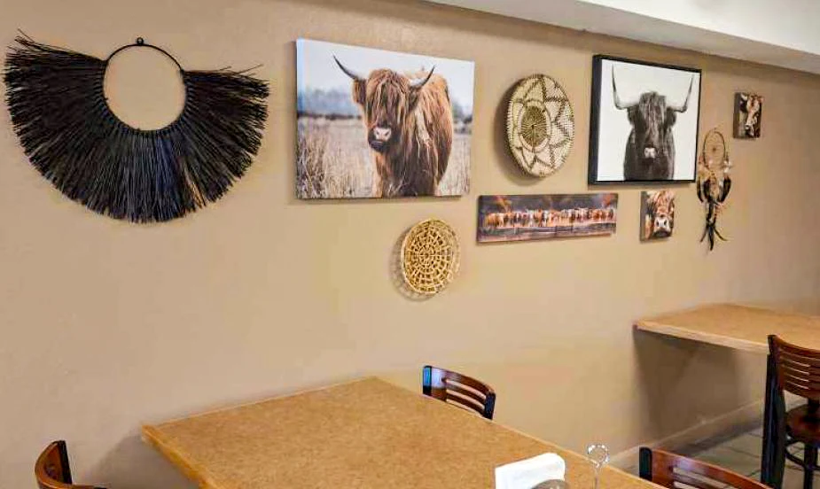 Dining area with wooden tables and decorative wall art