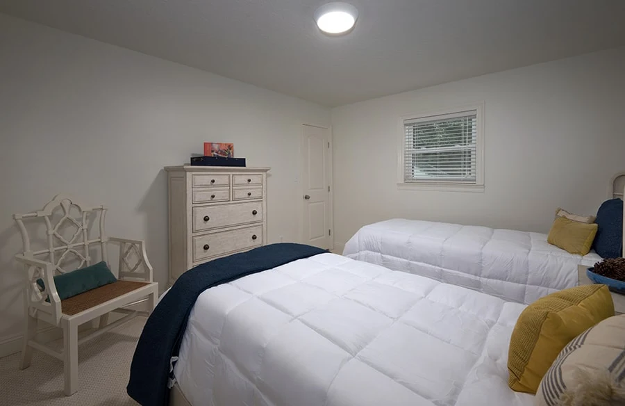 Shared bedroom with two beds and neutral decor