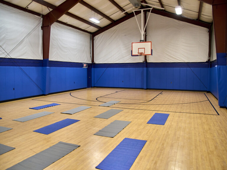 Wellness studio with yoga mats and basketball court