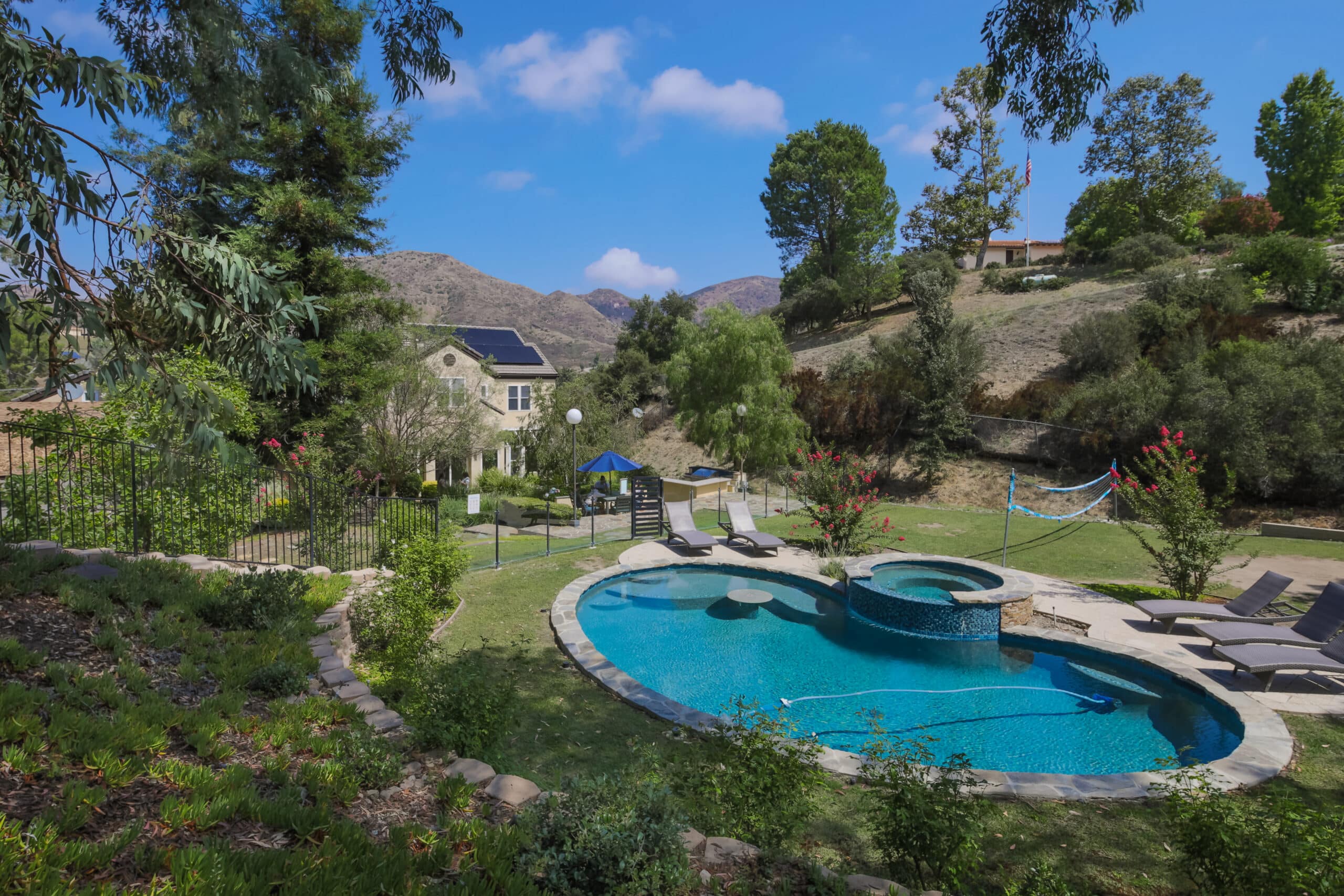 Outdoor pool with lounge chairs and hillside views