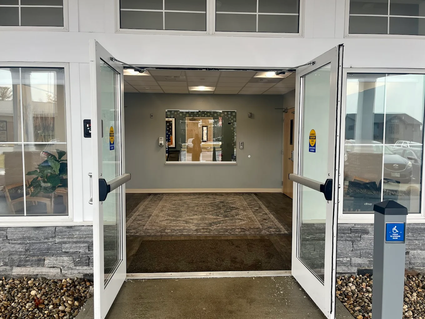 Open lobby with glass doors and reception area inside
