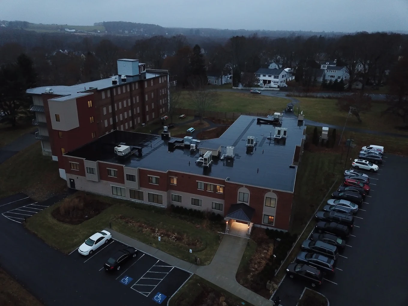 Aerial view of facility and parking lot at dusk