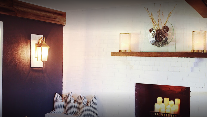 Lit fireplace with candles and decorative shelf