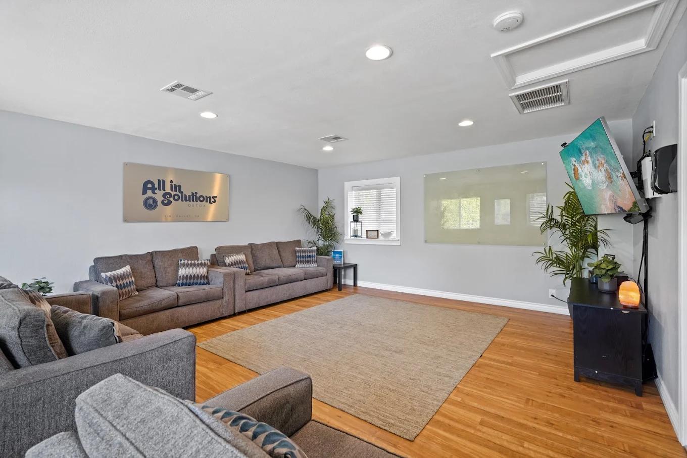 Gray couches with pillows in a bright living room