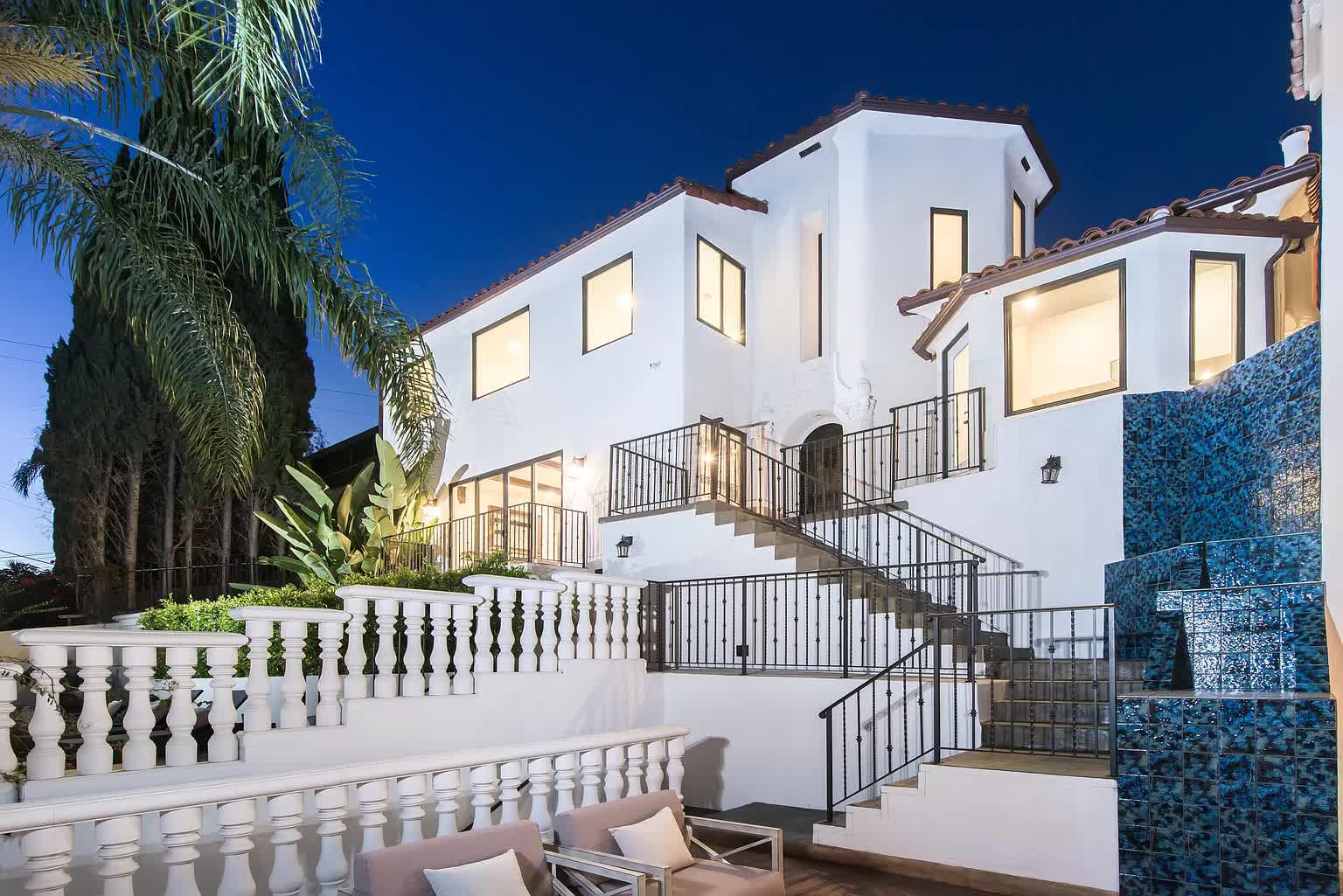 Exterior view of rehab facility with stairs and white facade