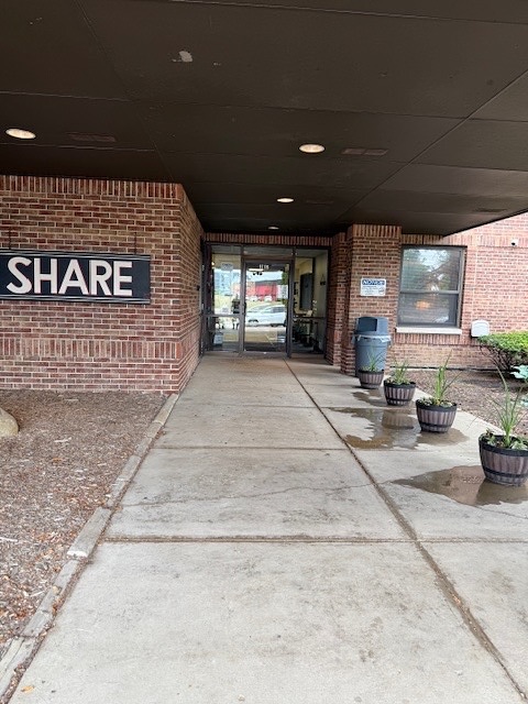 Main SHARE entrance walkway leading to glass doors at the facility.