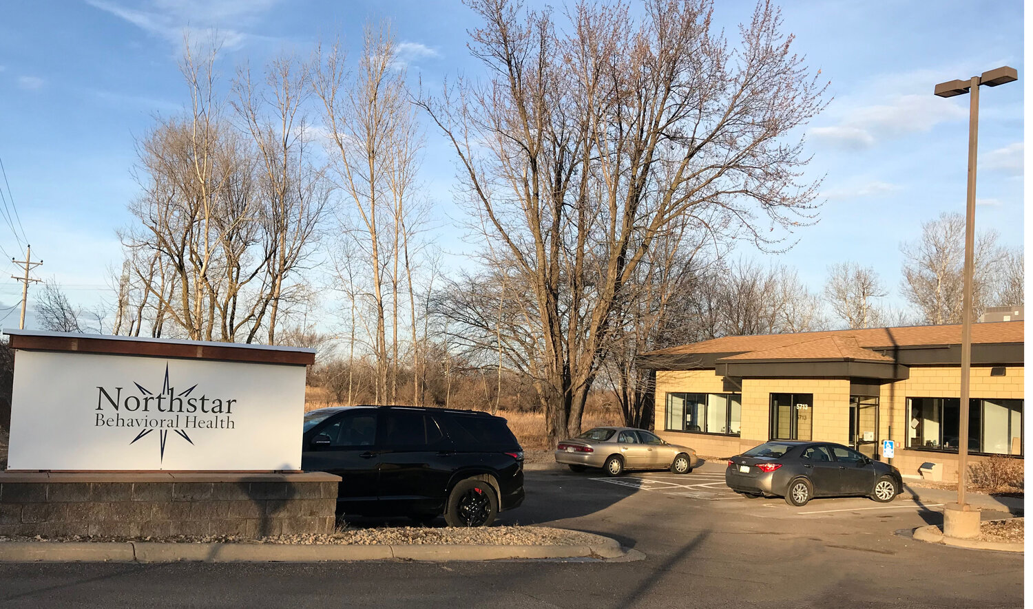 NorthStar sign and tan building with parked cars