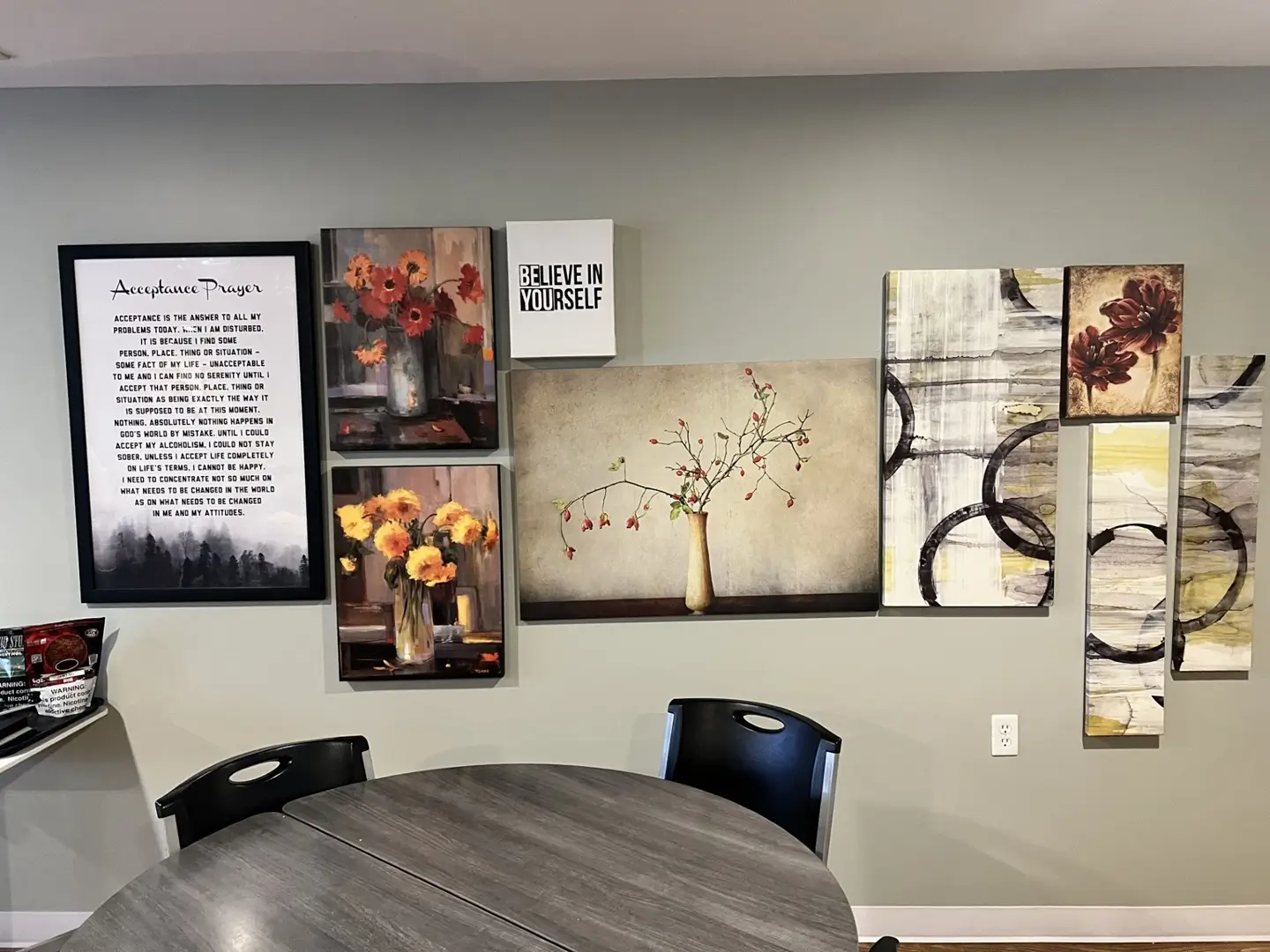 Communal dining area with tables and recovery artwork