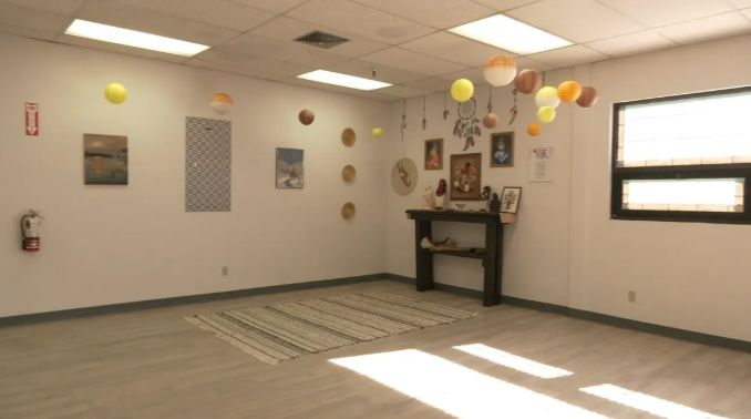 Calm meditation room with hanging decor and art on walls