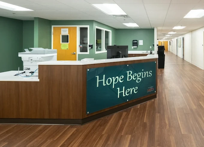 Rehab facility front desk with Hope Begins Here signage