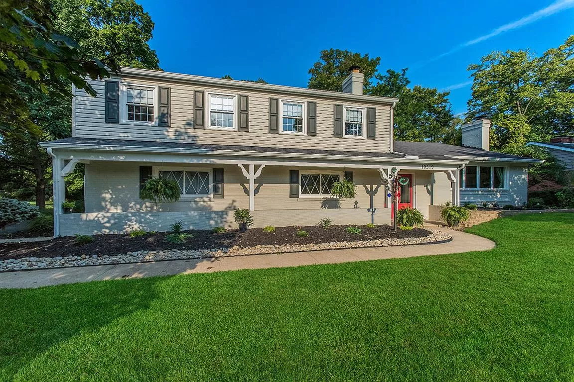 Upscale building surrounded by trees and front lawn.