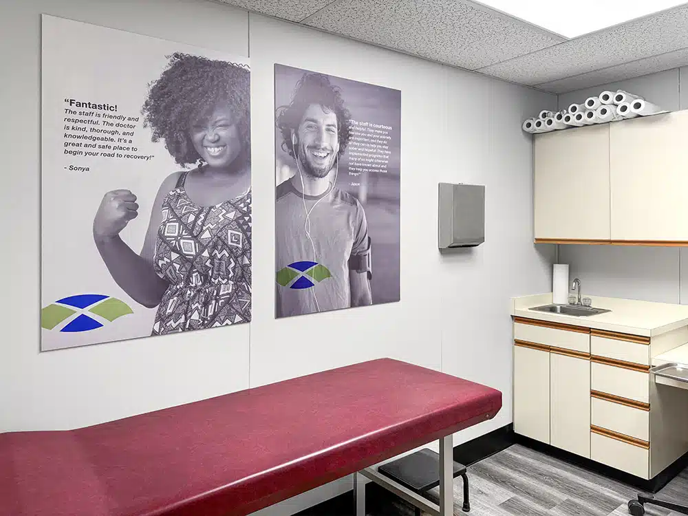 Exam room with red table, sink, and wall posters