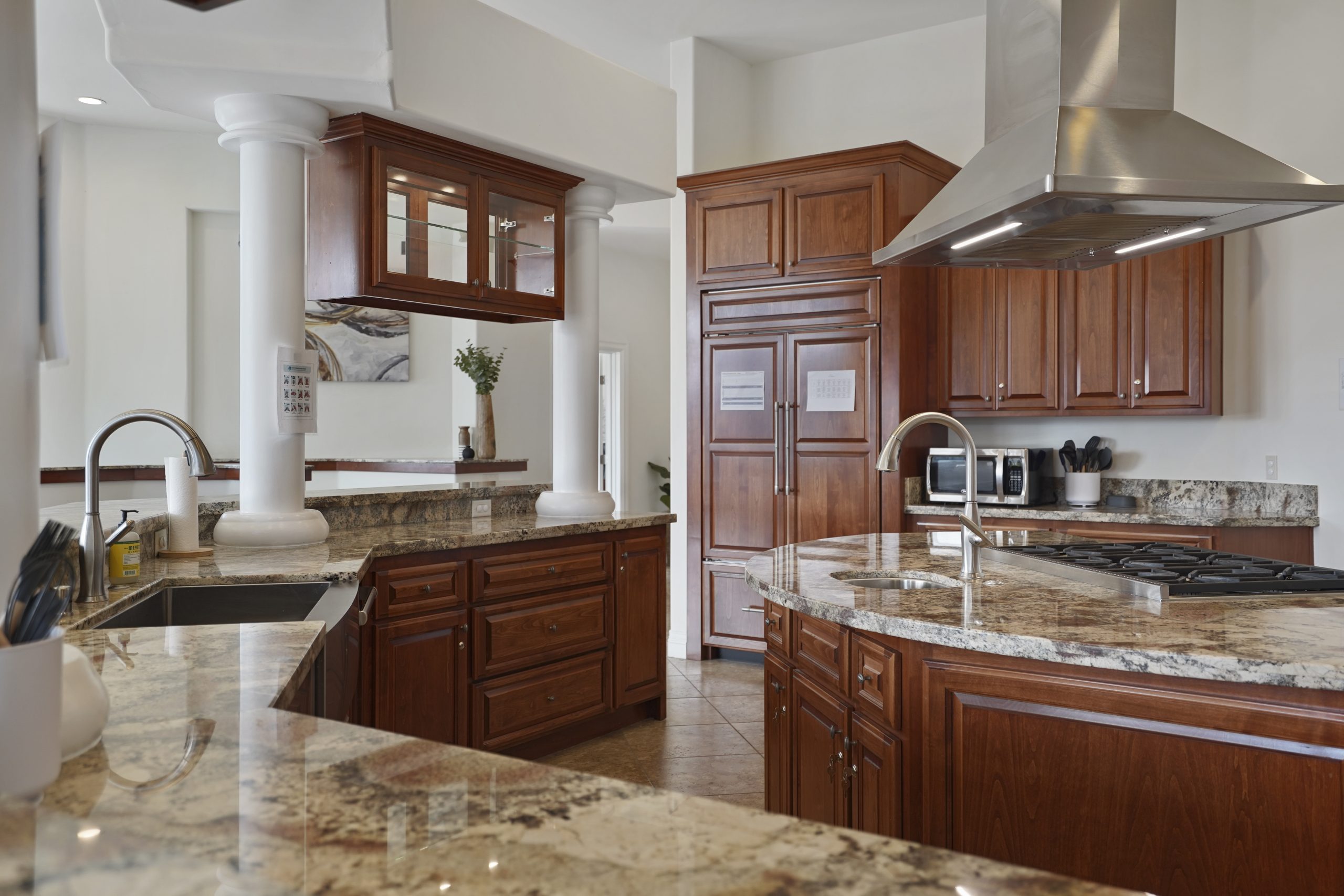 Spacious kitchen with wood cabinets and granite countertops.