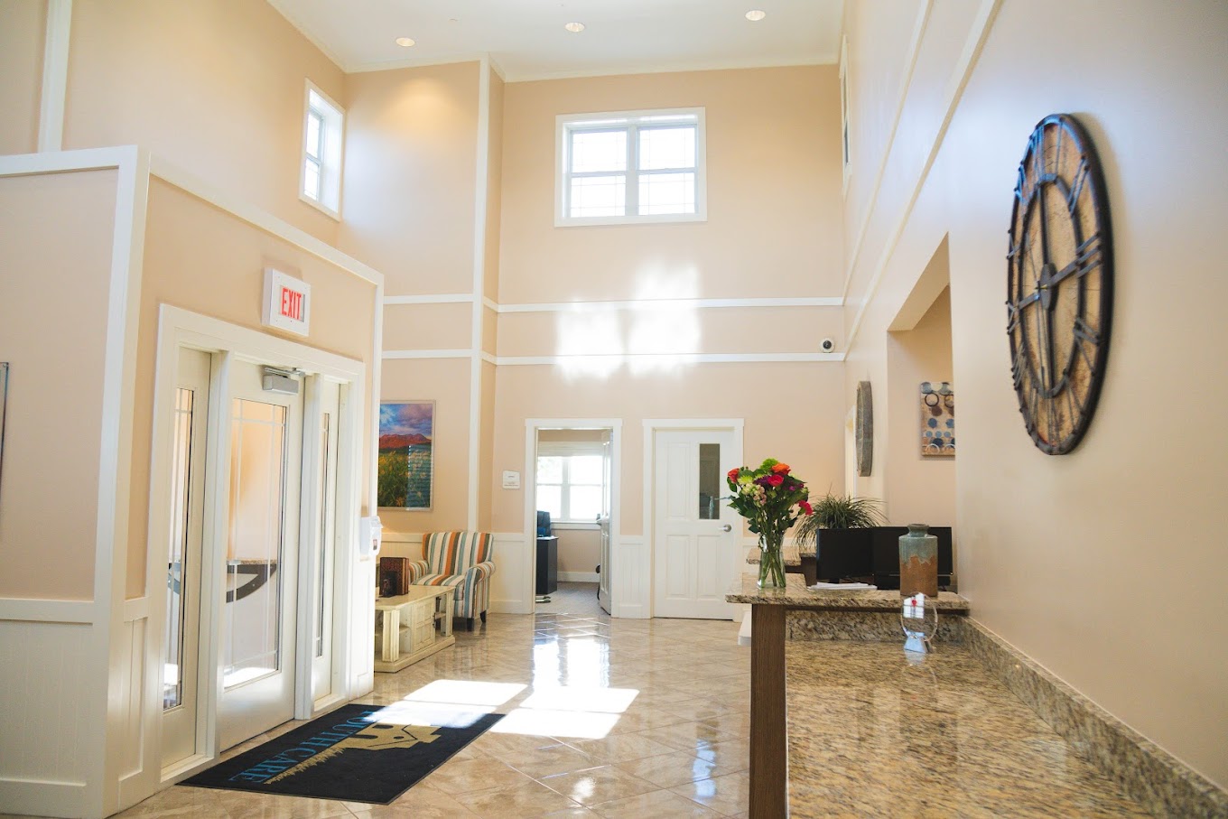 Bright front lobby with check-in desk and natural lighting