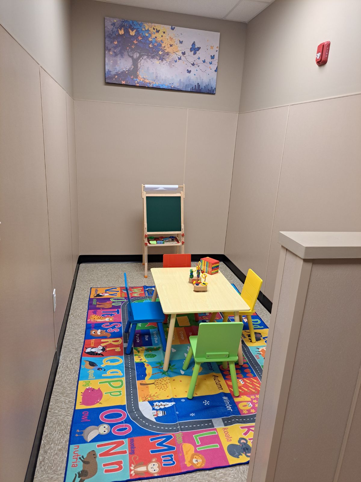 Child-friendly area with small table, chairs, and toys.