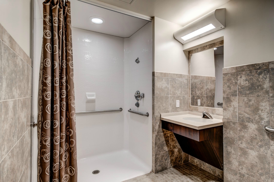 Walk-in shower and sink with support rails