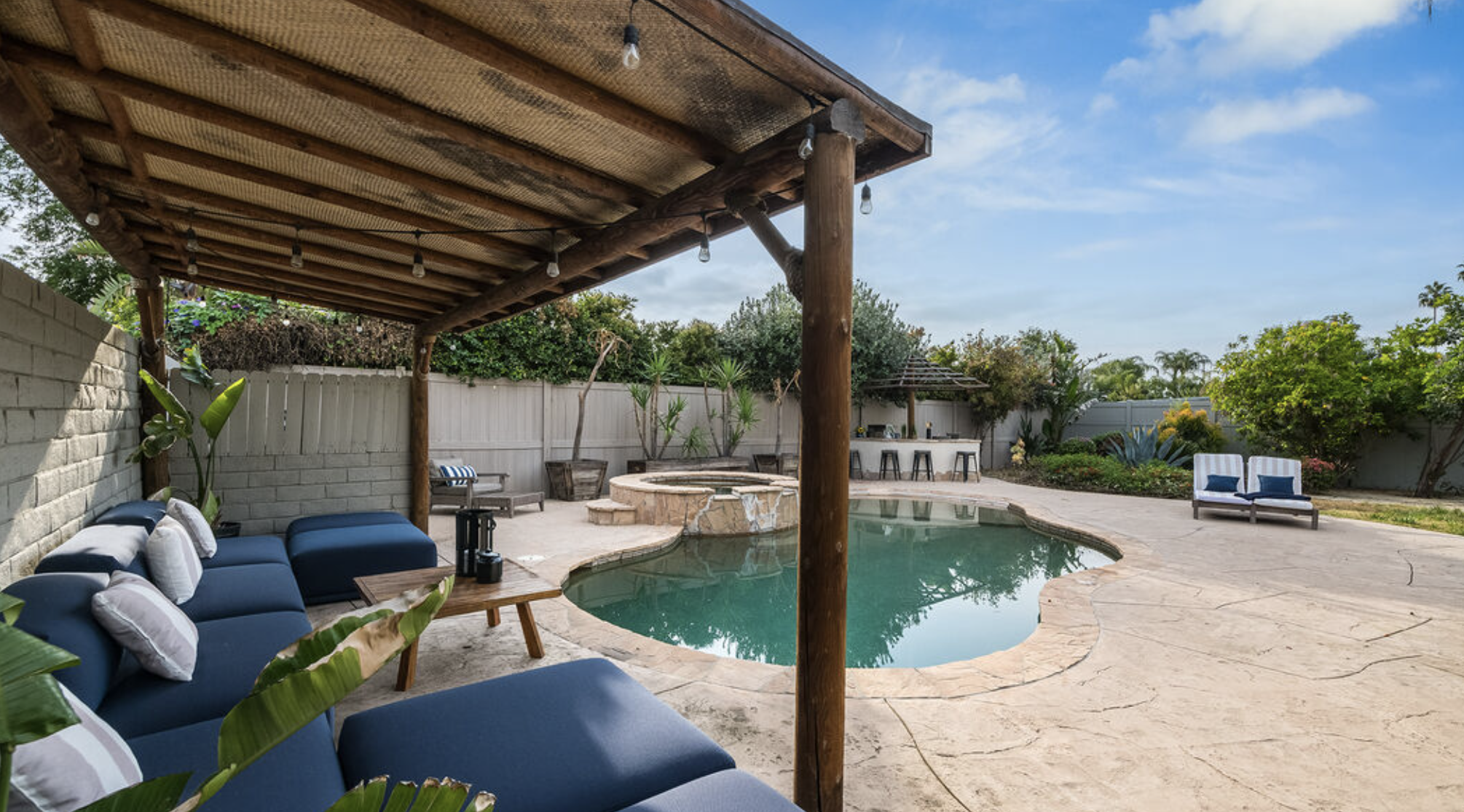 Backyard pool with lounge seating and hot tub