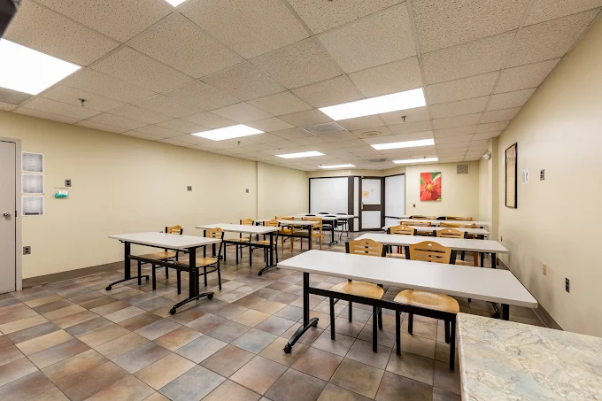 Therapy room with desks, chairs, and bright lighting