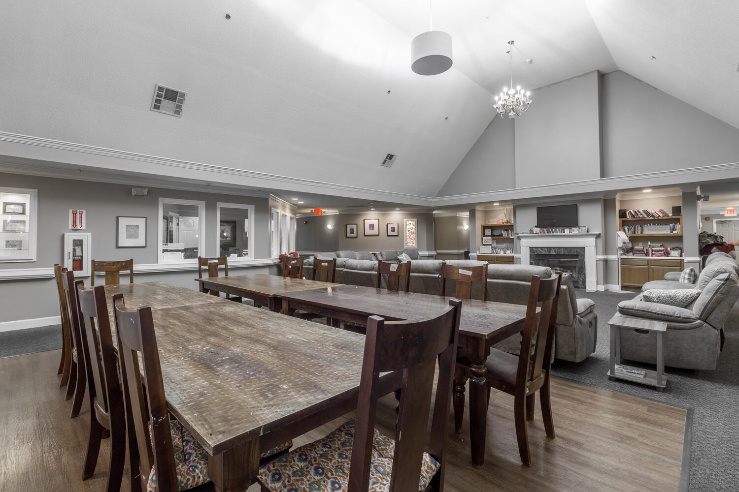 Wood tables and couches in high-ceilinged dining hall