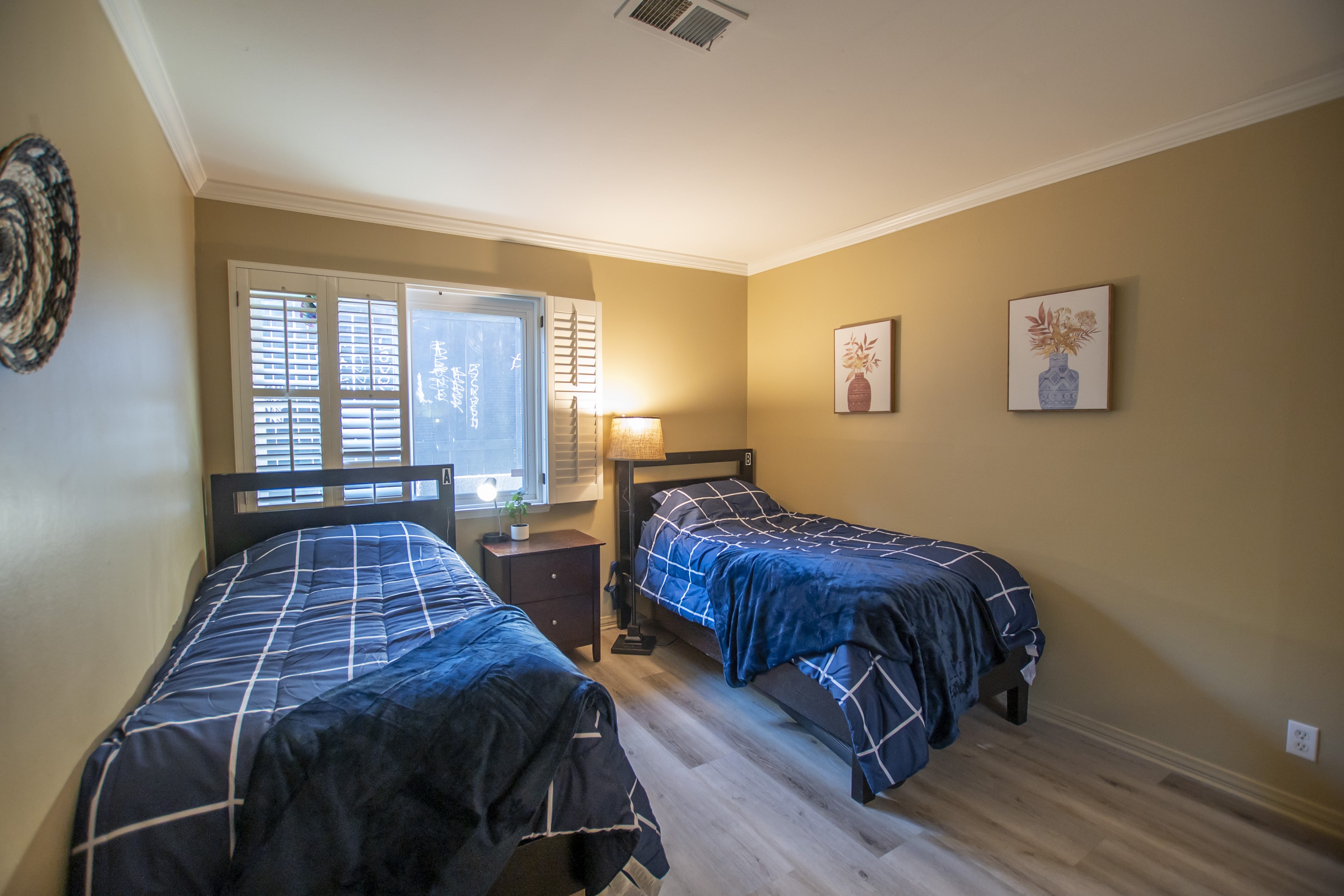Twin beds with blue bedding in shared room