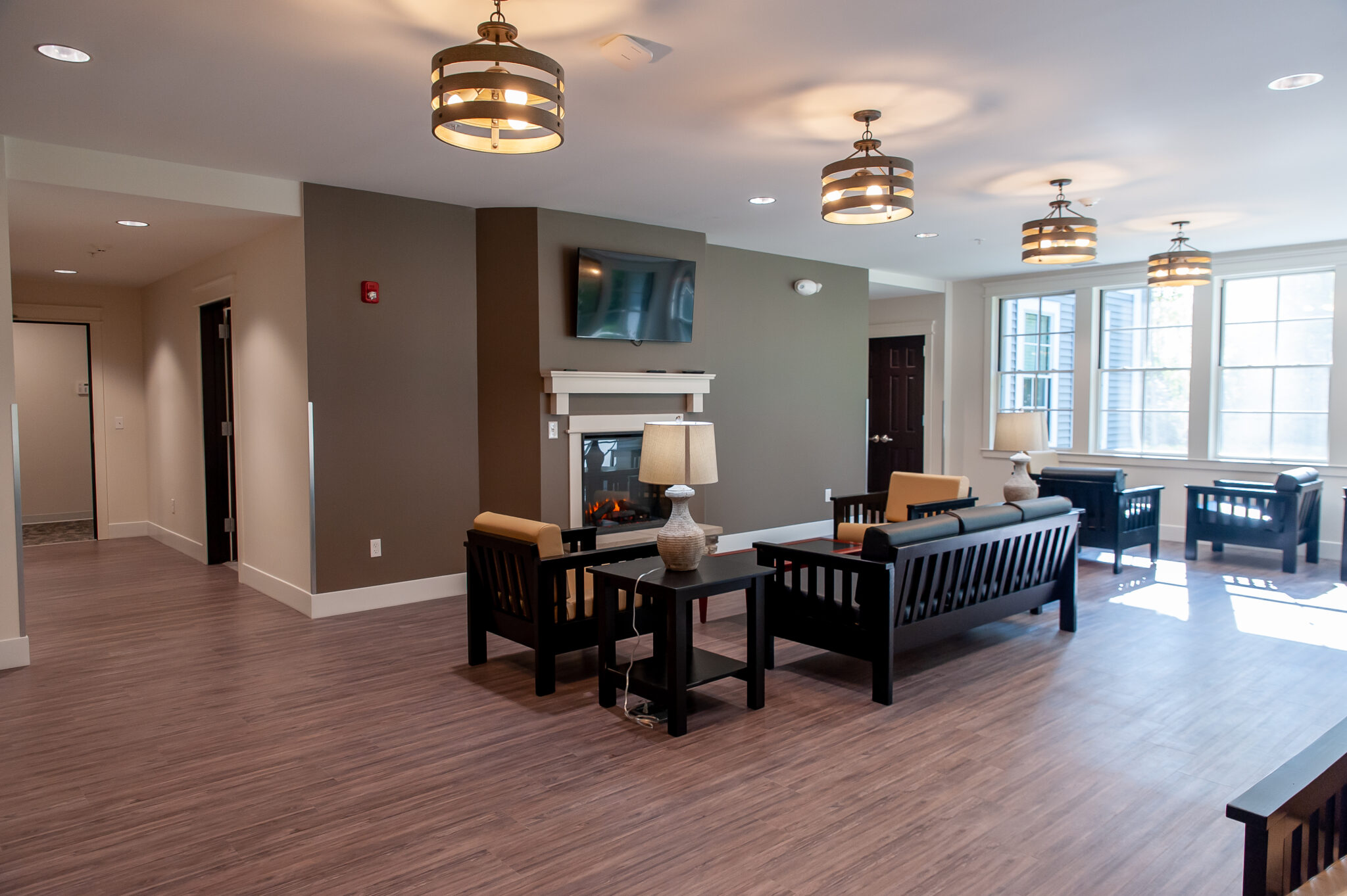 Lounge with seating, fireplace, and wall-mounted television
