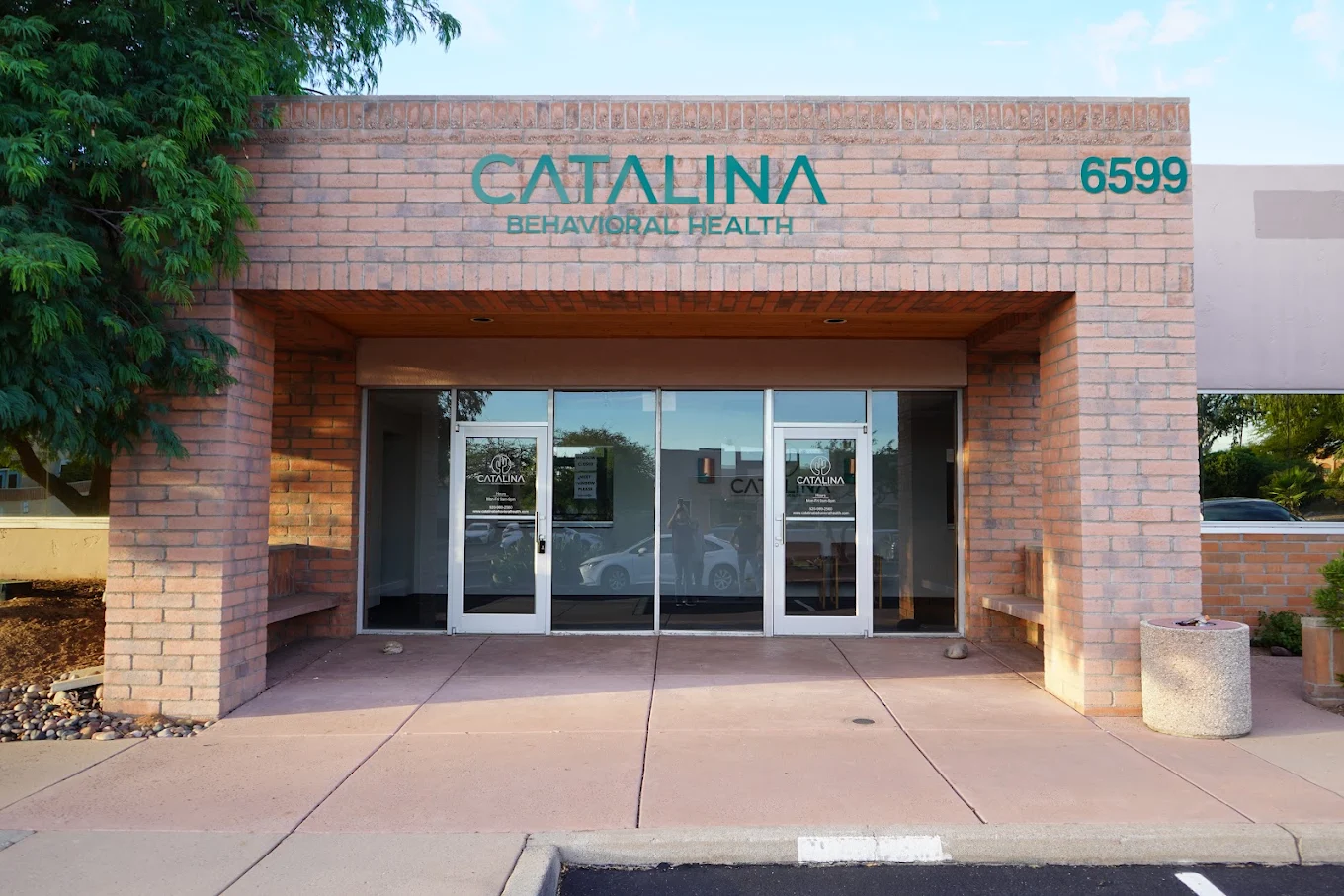 Main entrance to Catalina Behavioral Health in Tucson with brick exterior and glass doors
