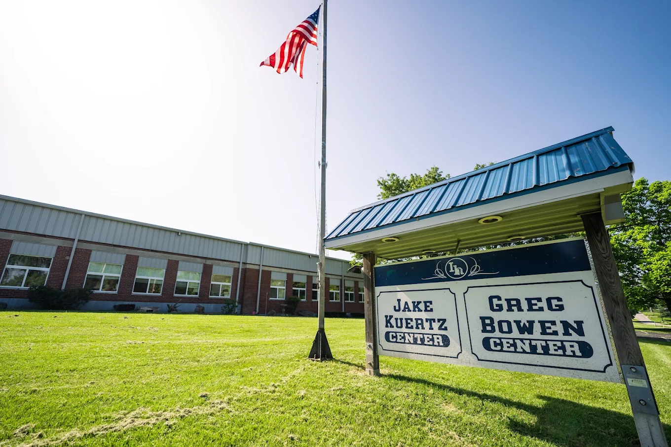 Jake Kuertz Center exterior with lawn and American flag