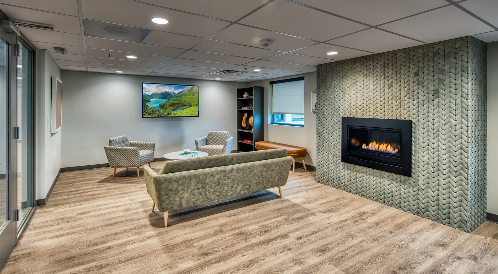 Fireplace lounge with couch, chairs, and TV