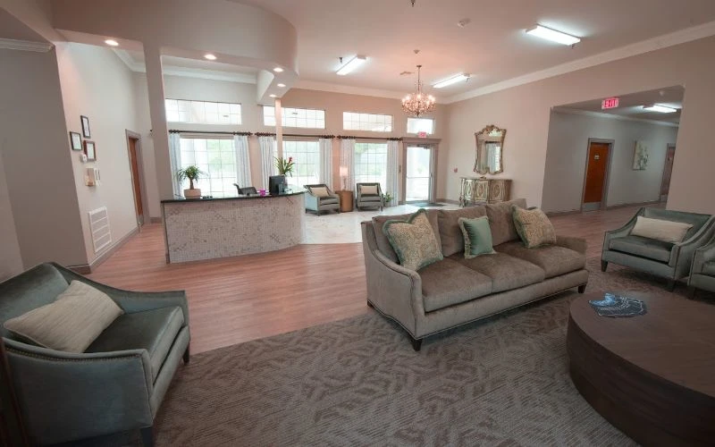 Lobby with chandelier, sofas, and natural lighting