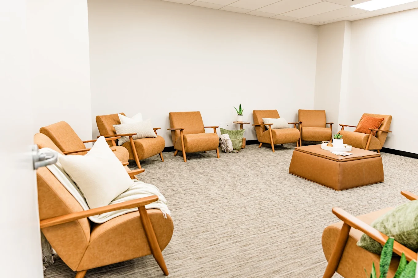 Group therapy room with comfortable chairs in a circle