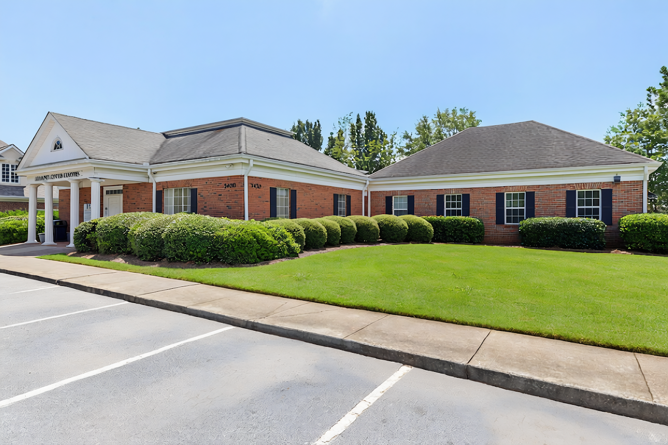 Brick treatment facility with landscaped lawn and parking area