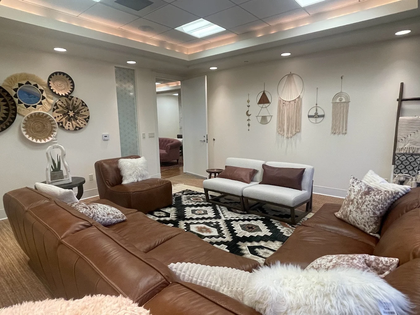 Leather sectional and chairs arranged for group sessions