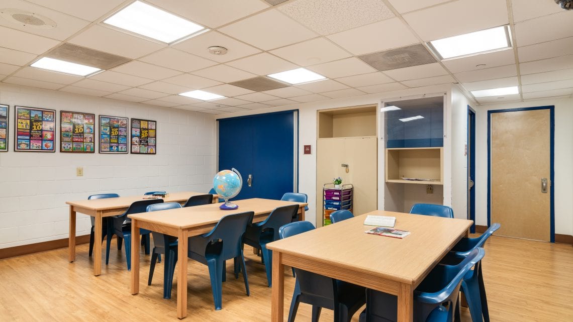 Classroom with globe, posters, and study tables
