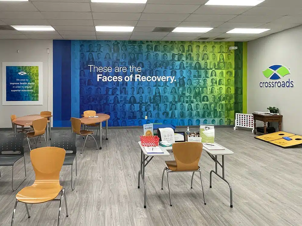 Group room with chairs, tables, and recovery mural