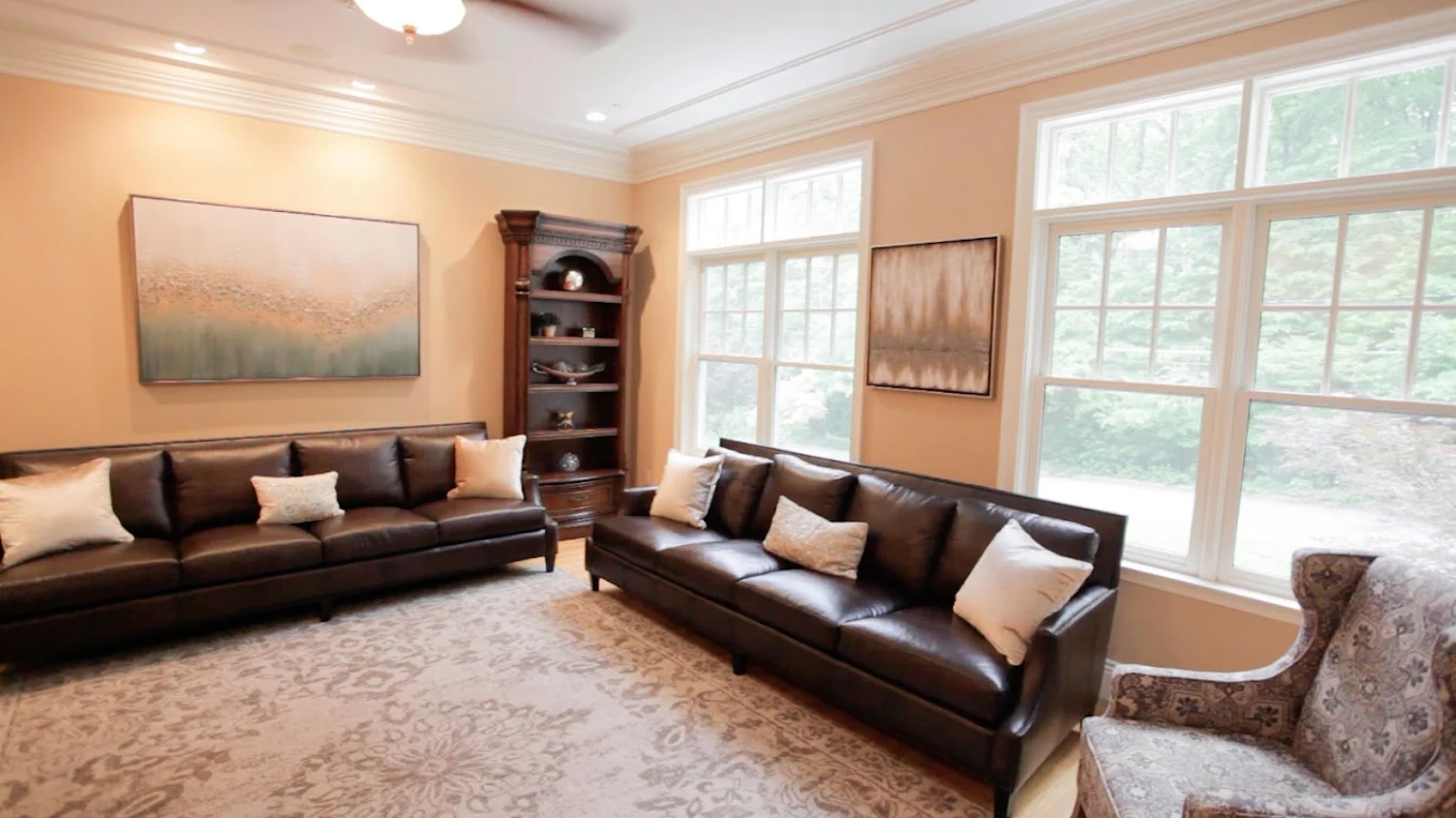 Group therapy room with leather sofas and large windows