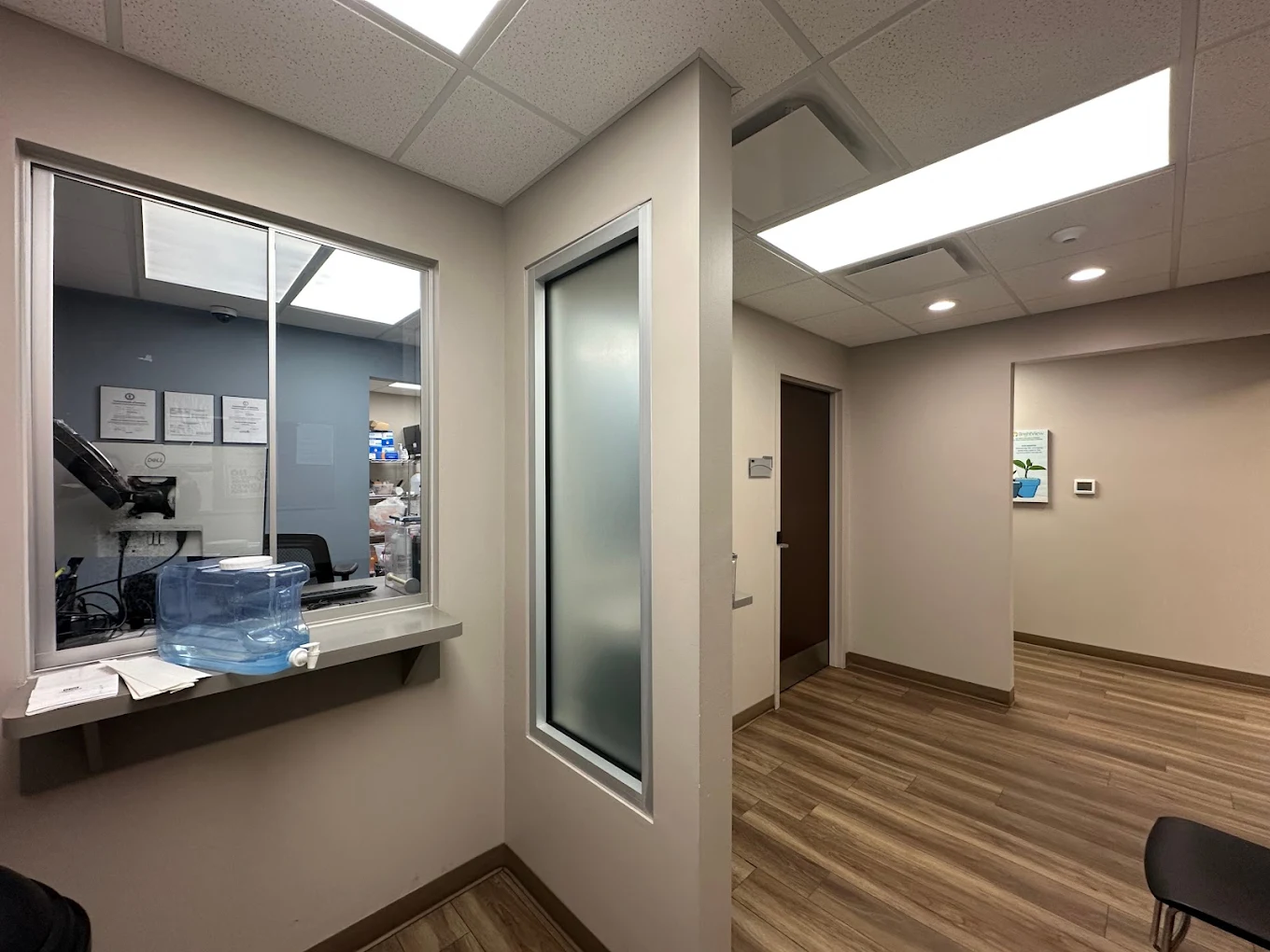 Medication dispensing area with service window and clinical workspace